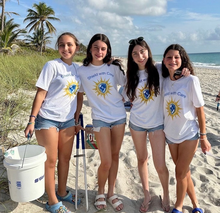 Shield With Care volunteers at a beach cleanup